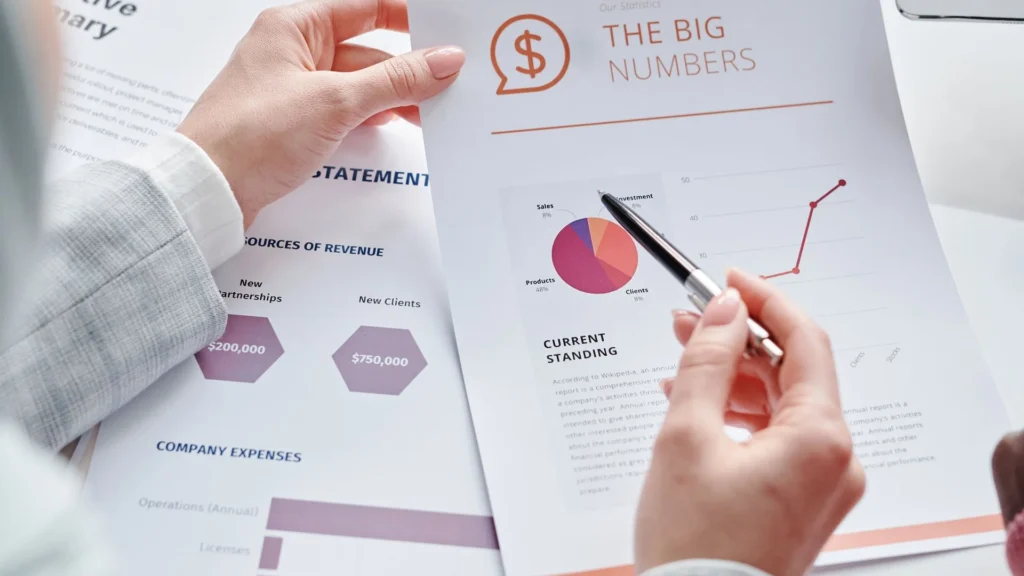 Financial charts and statistics being discussed at a meeting
