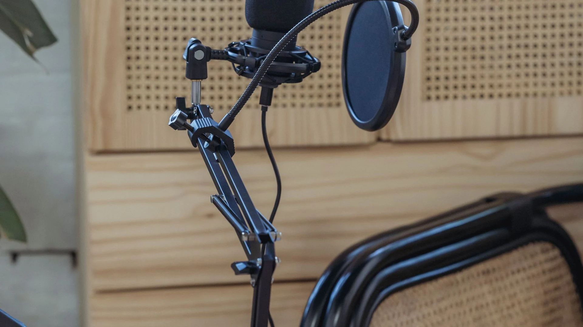 Microphone and laptop in a warm recording space prepared for an interview