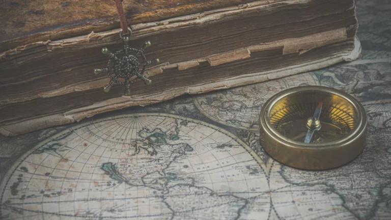 Antique map, compass and book arranged for historical research