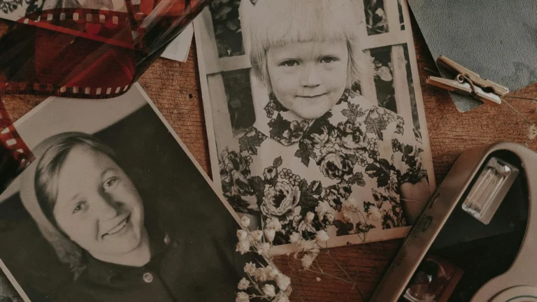Vintage printed family photographs with a camera and film negatives