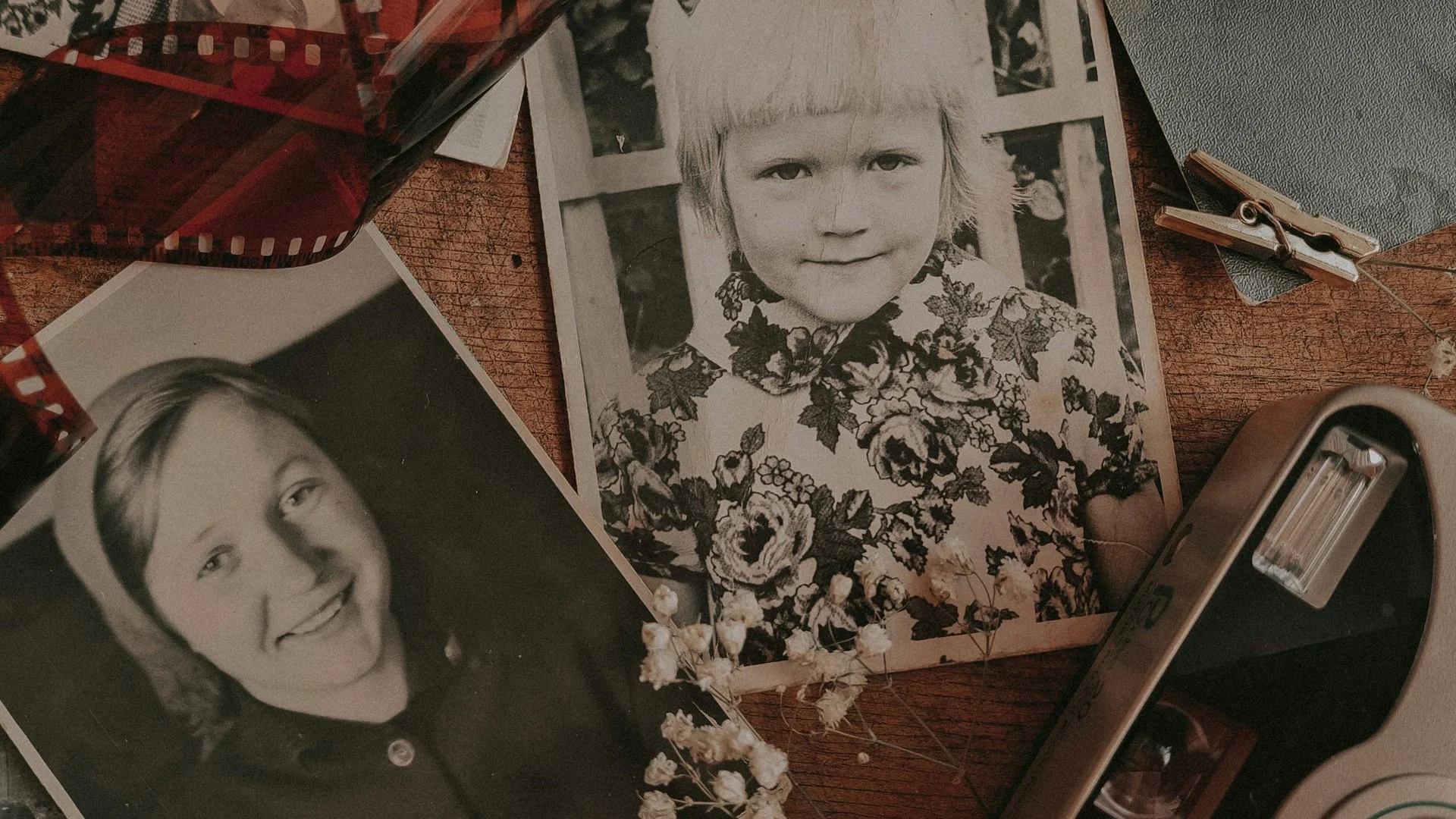 Vintage printed family photographs with a camera and film negatives
