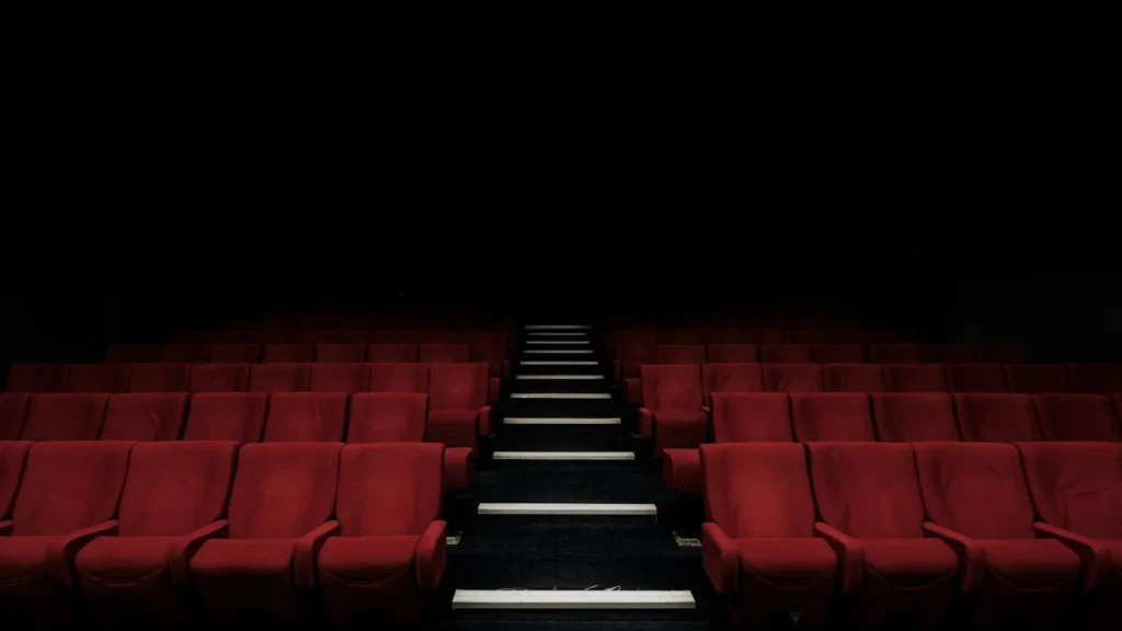 Rows of red seats inside a cinema auditorium