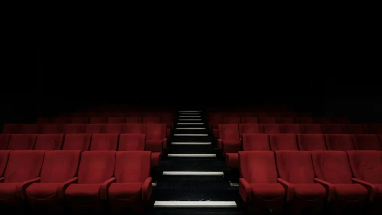 Rows of red seats inside a cinema auditorium