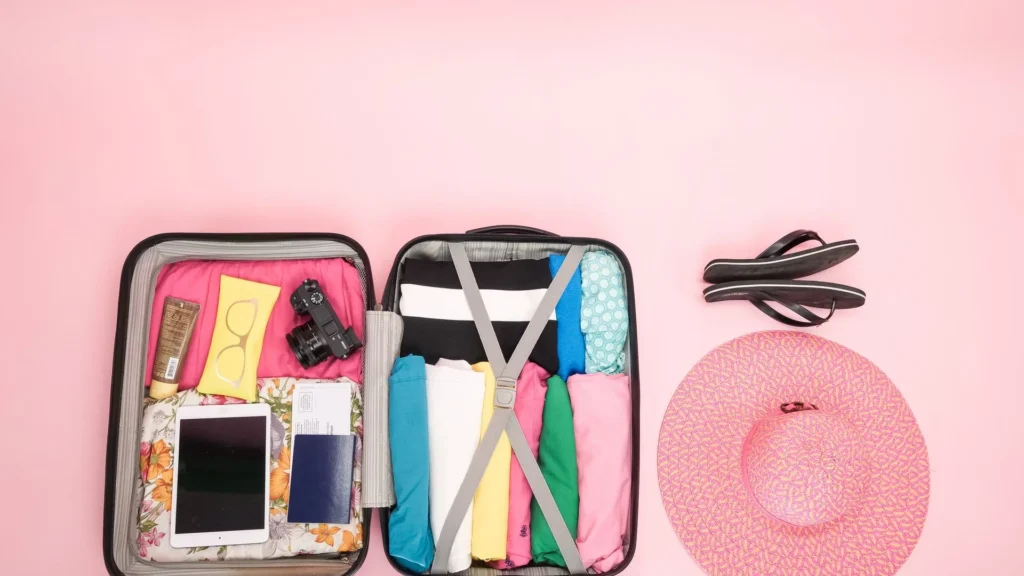 Open suitcase neatly packed with clothes and travel essentials