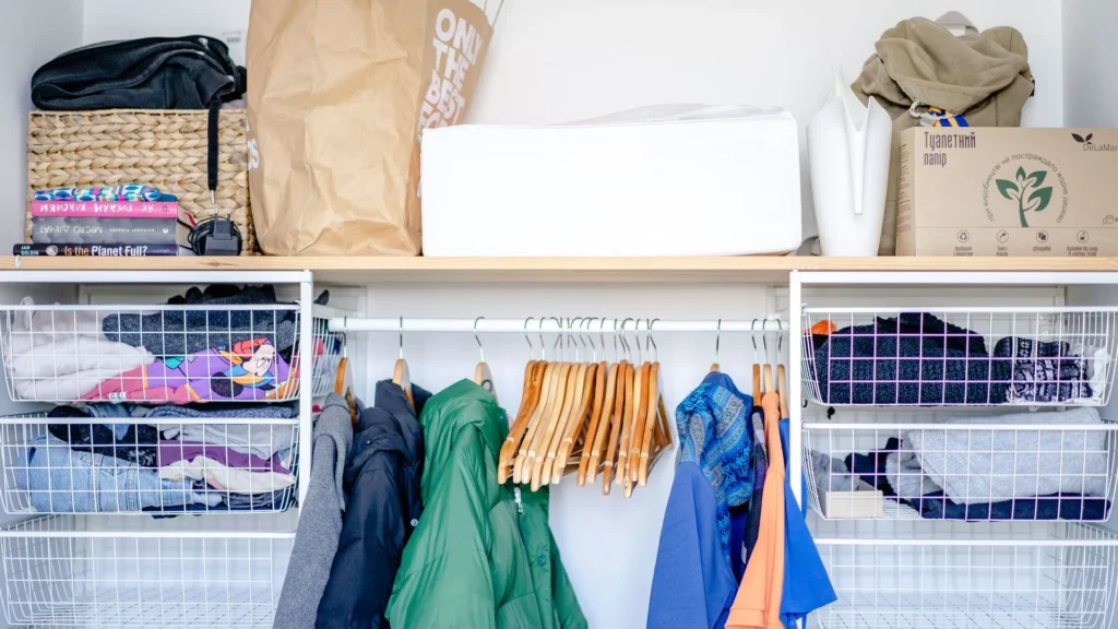Organised open wardrobe with clothing and storage baskets
