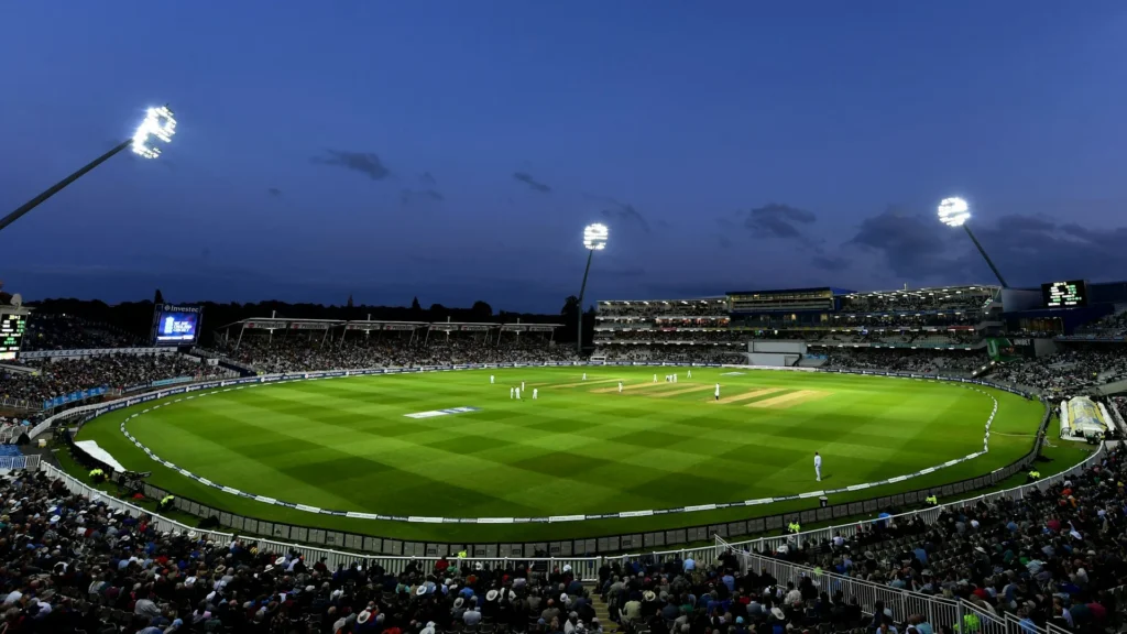 Illuminated cricket stadium viewed from the stands