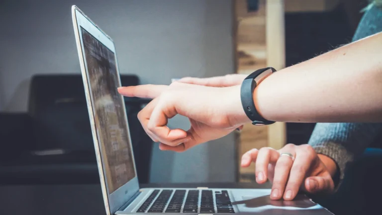 People working together at a laptop in a bright office